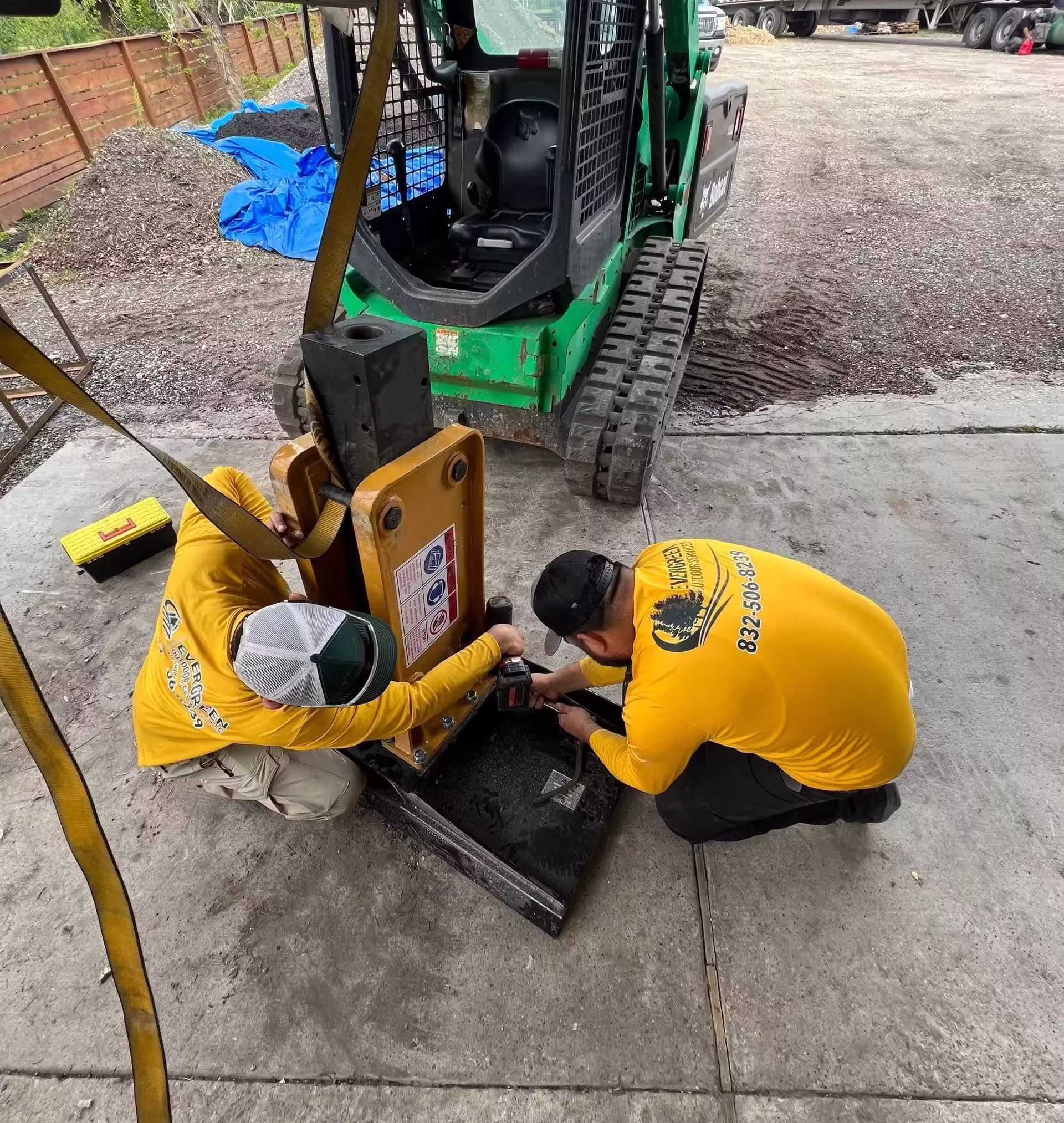 2 Men repairing a heavy duty attachment for heavy machinery FOR THE CUSTOMER SATISFACTION GUARANTEED WE ARE ALWAYS SERVCIING EQUIOMENT FOR LITTLE TO NO DELAYS.