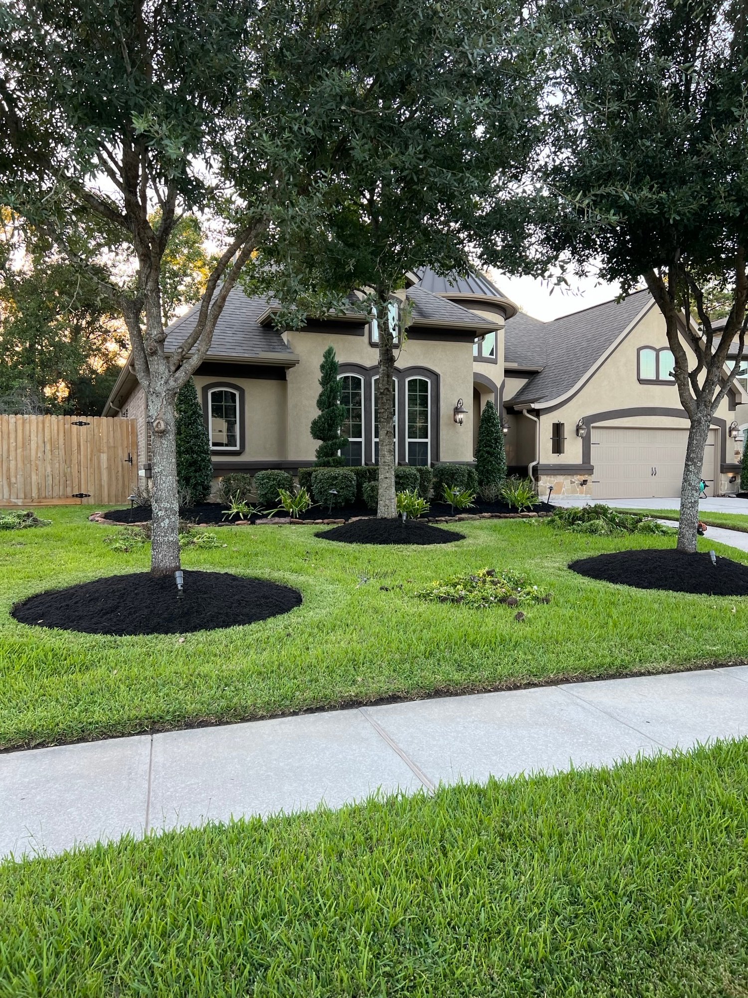 Evergreen Outdoor Services team providing early spring landscape maintenance for a Summerwood home in Houston