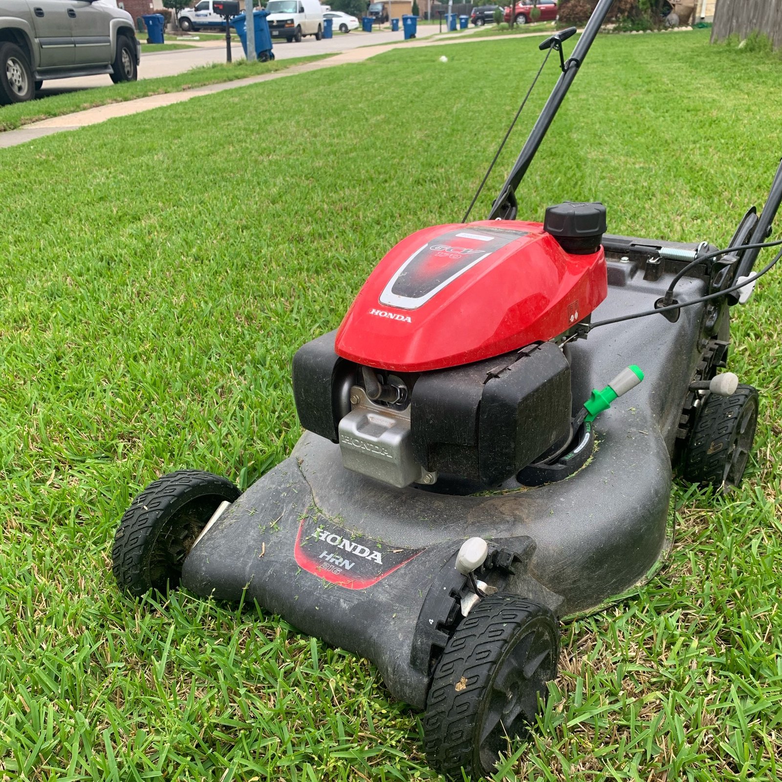 Honda push mower on a lawn with freshly cut grass, highlighting clean and precise mowing lines.