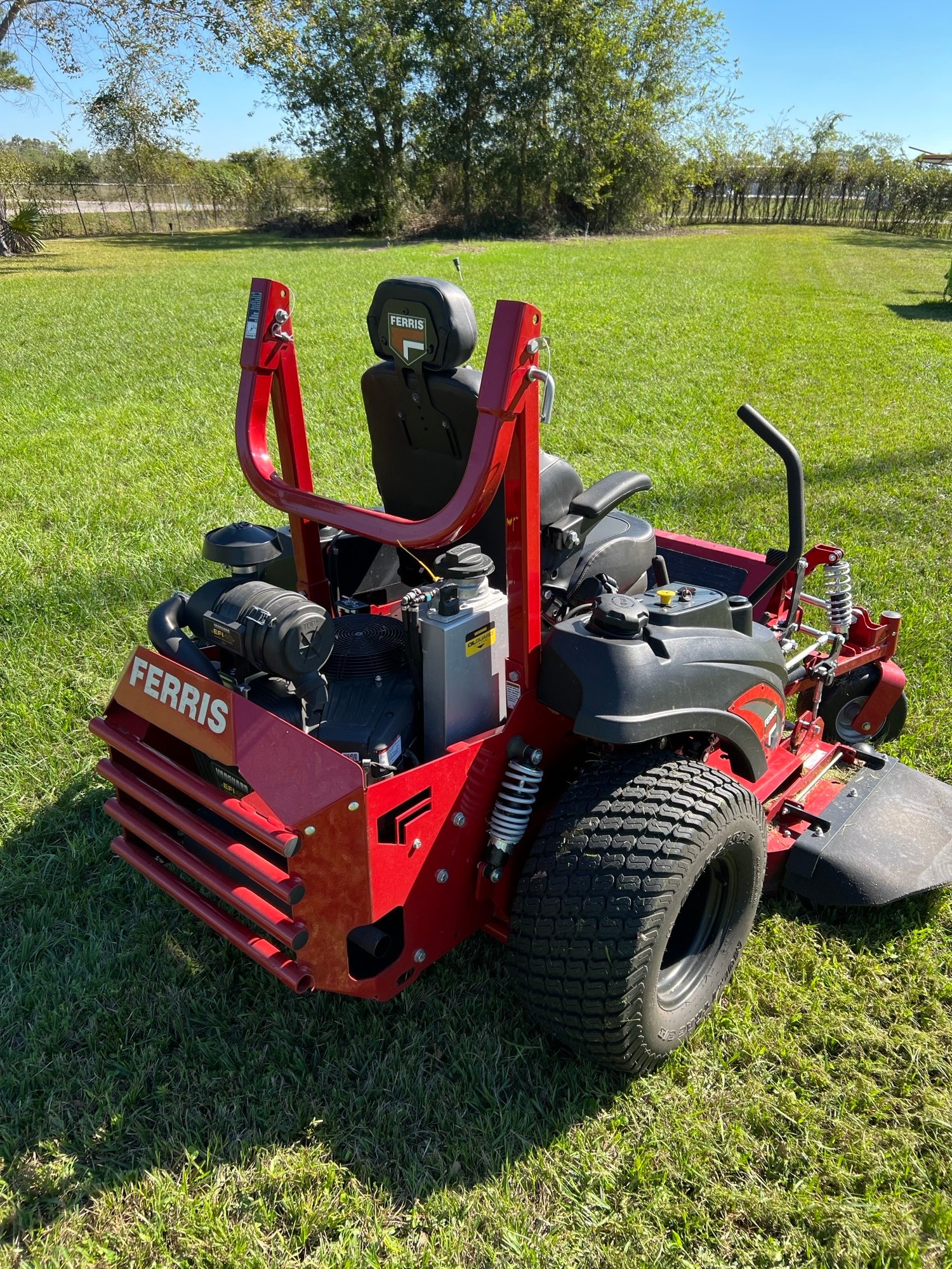 Commercial lawn care in action with a high-performance mowing machine maintaining a lush, green open lawn, delivering a clean and polished appearance.