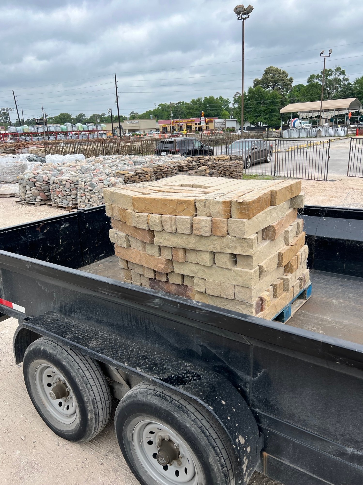 Pallet of creamy Texas chopped stone loaded on a trailer, ready for landscape delivery or installation
