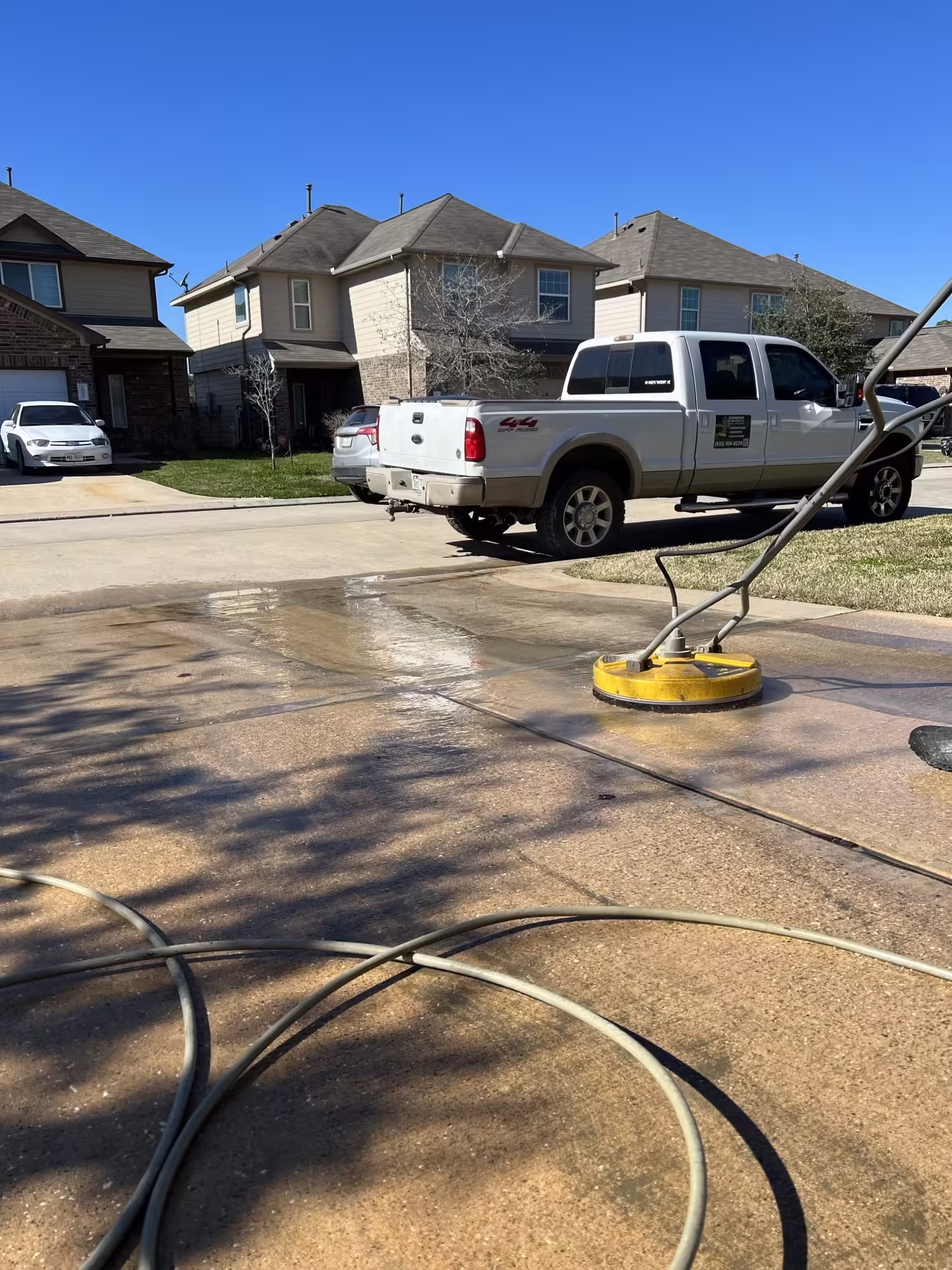 Residential driveway surface cleaning with pressure washing equipment in Houston