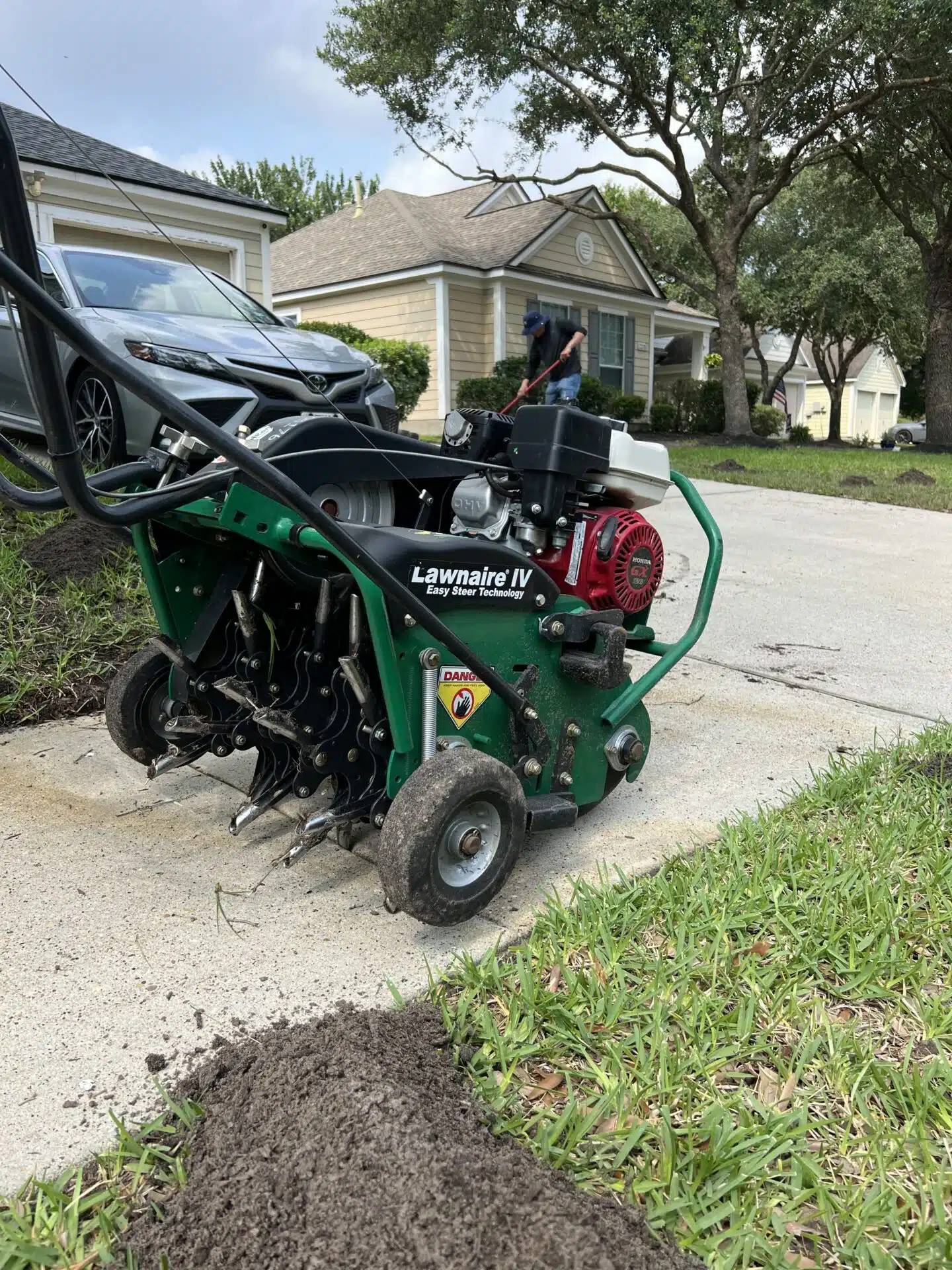 Core aeration equipment prepared for service on a residential lawn