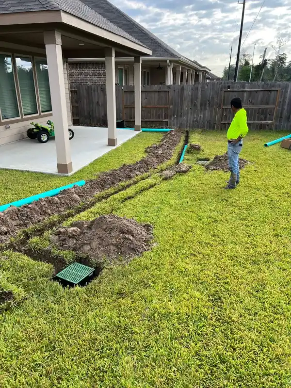 Professional surface drain installation in a Houston backyard