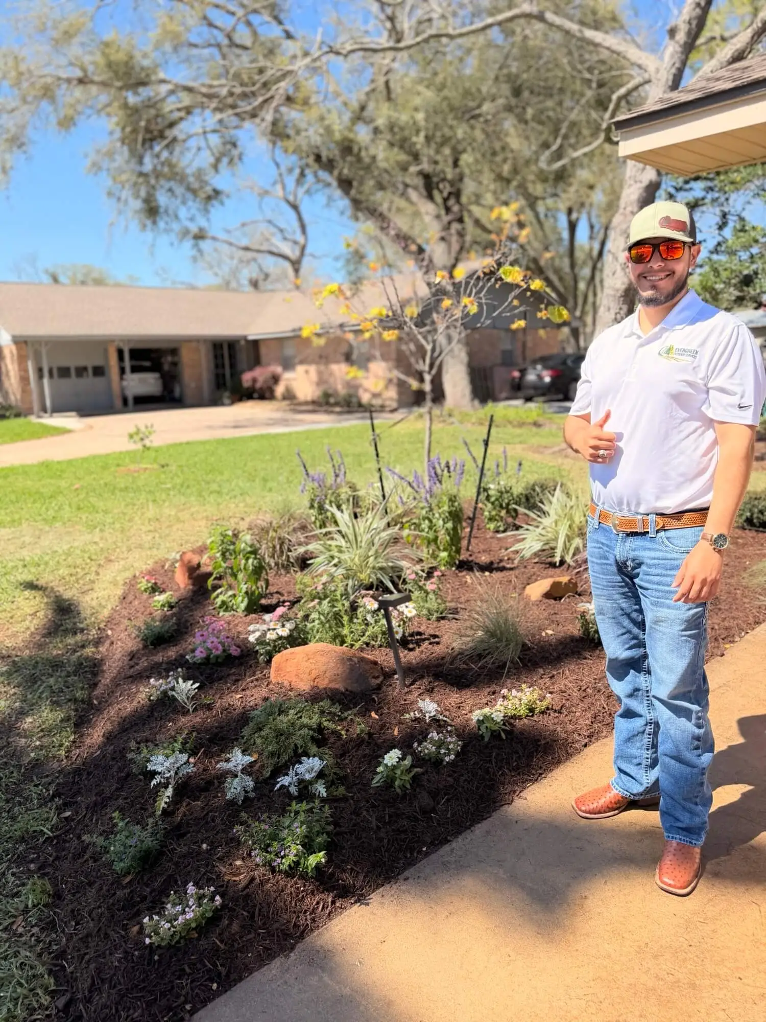 Evergreen Outdoor Services pro standing in a perfectly maintained Houston yard