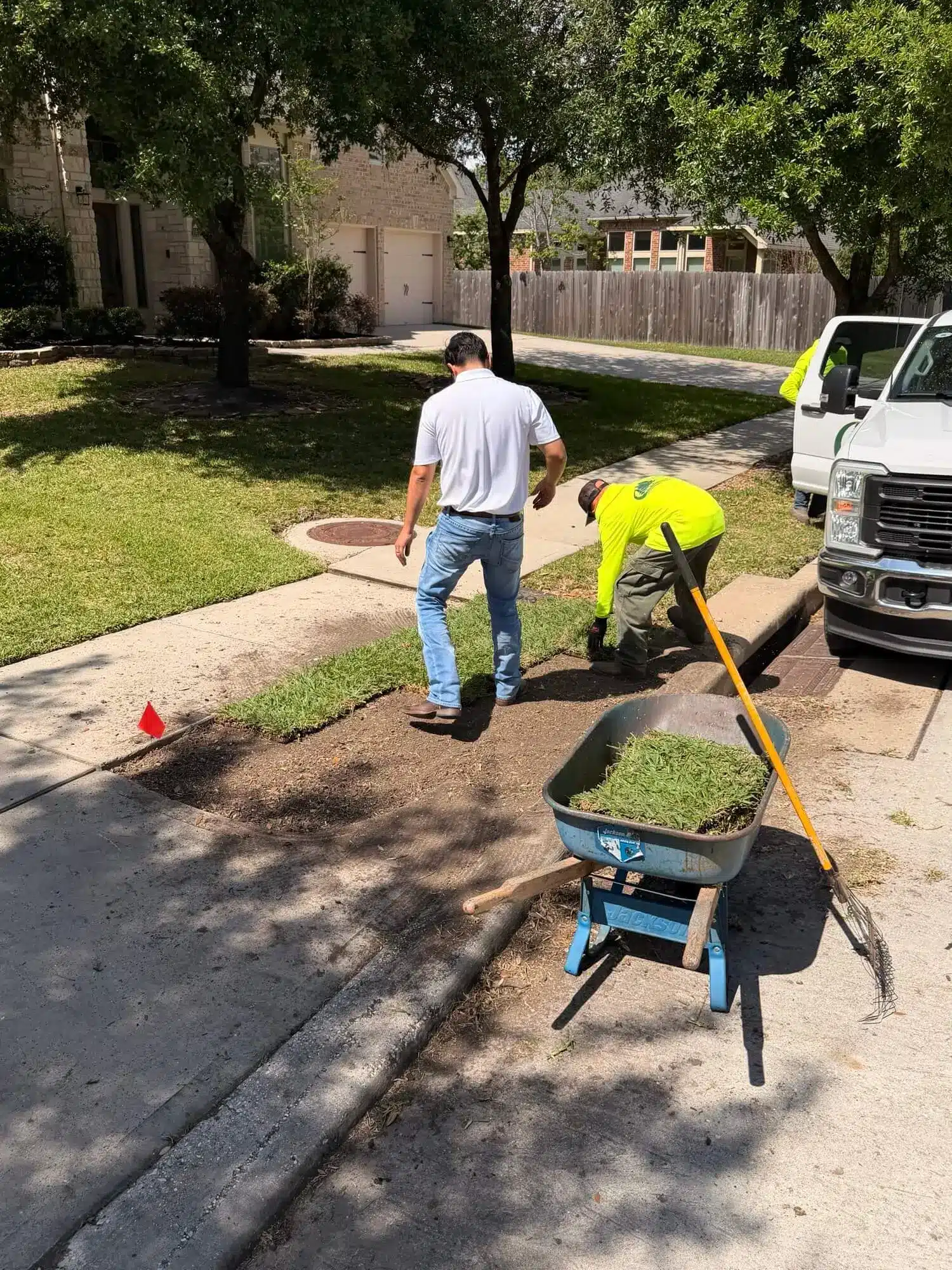 Professional sod installation in Houston showing proper roll placement technique
