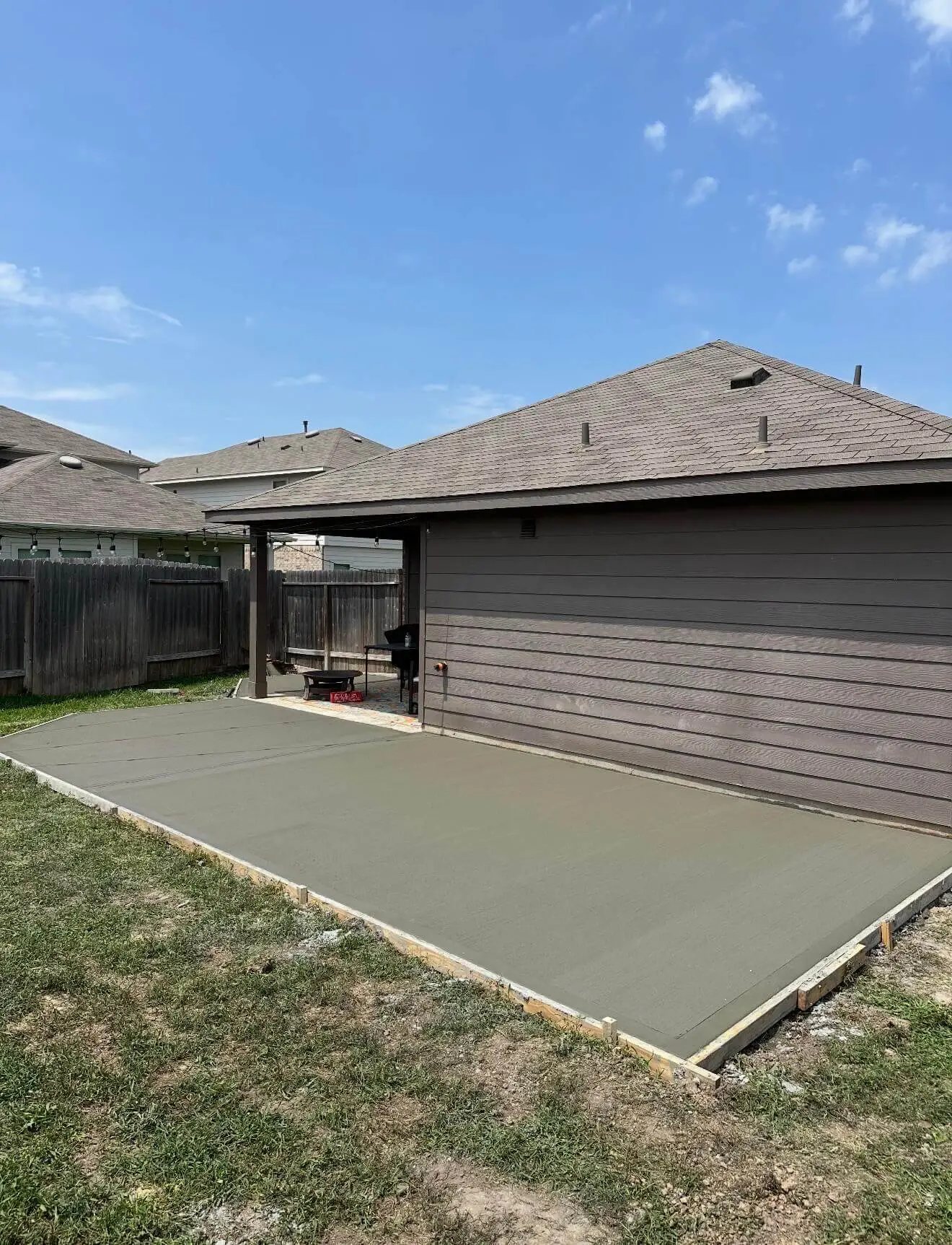 Backyard concrete patio extension for a Houston outdoor space
