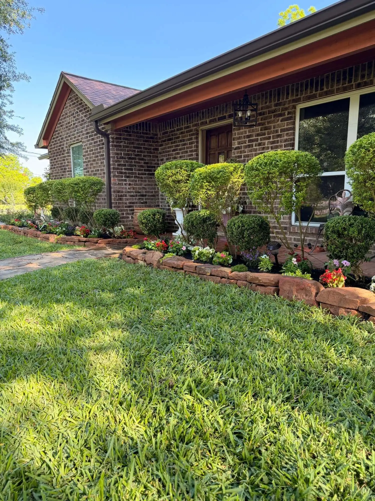 Evergreen Services in Houston moss rock garden border installation