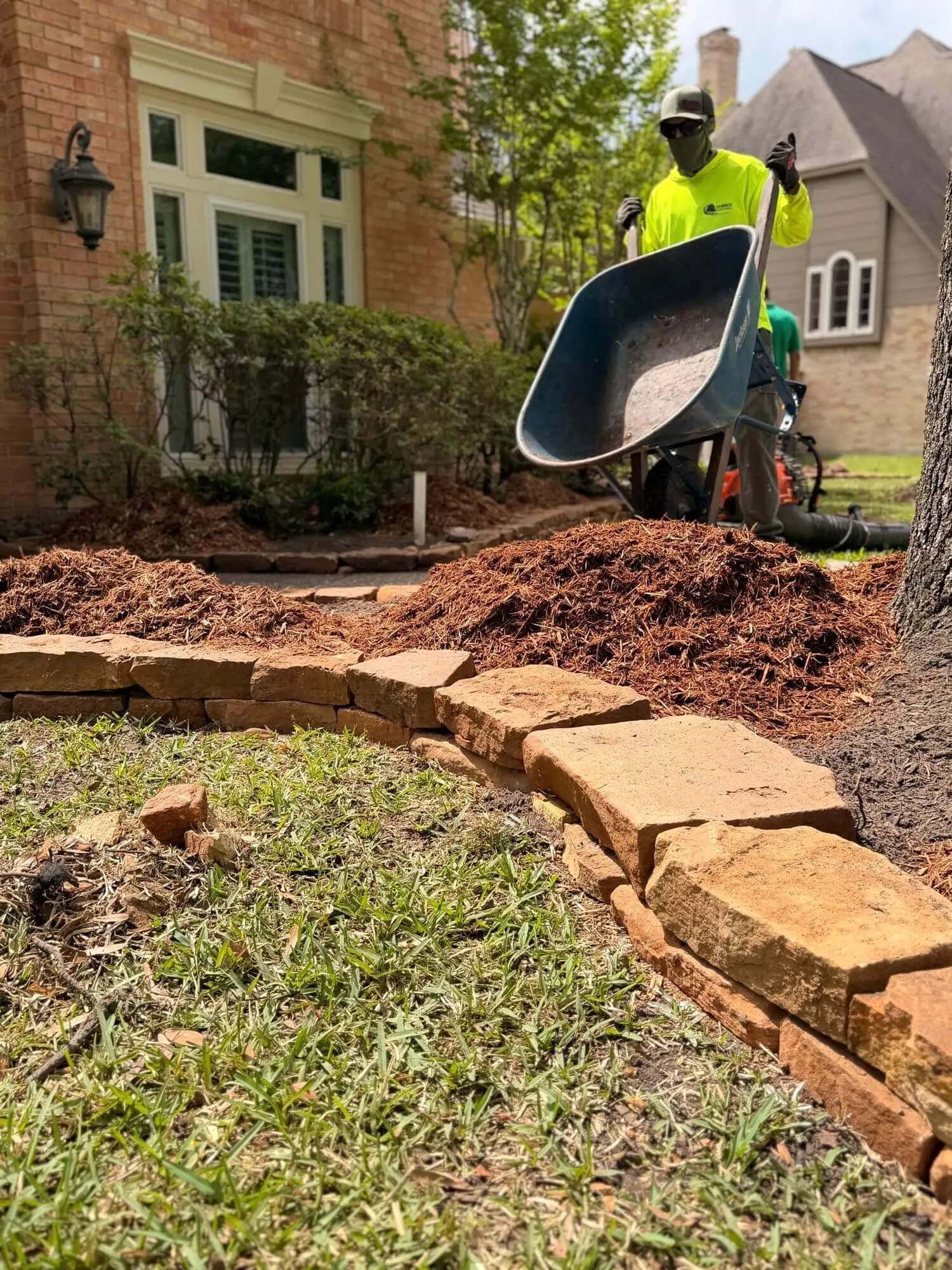 Moss rock stacker installation in Kingwood Texas by Evergreen Outdoor Services