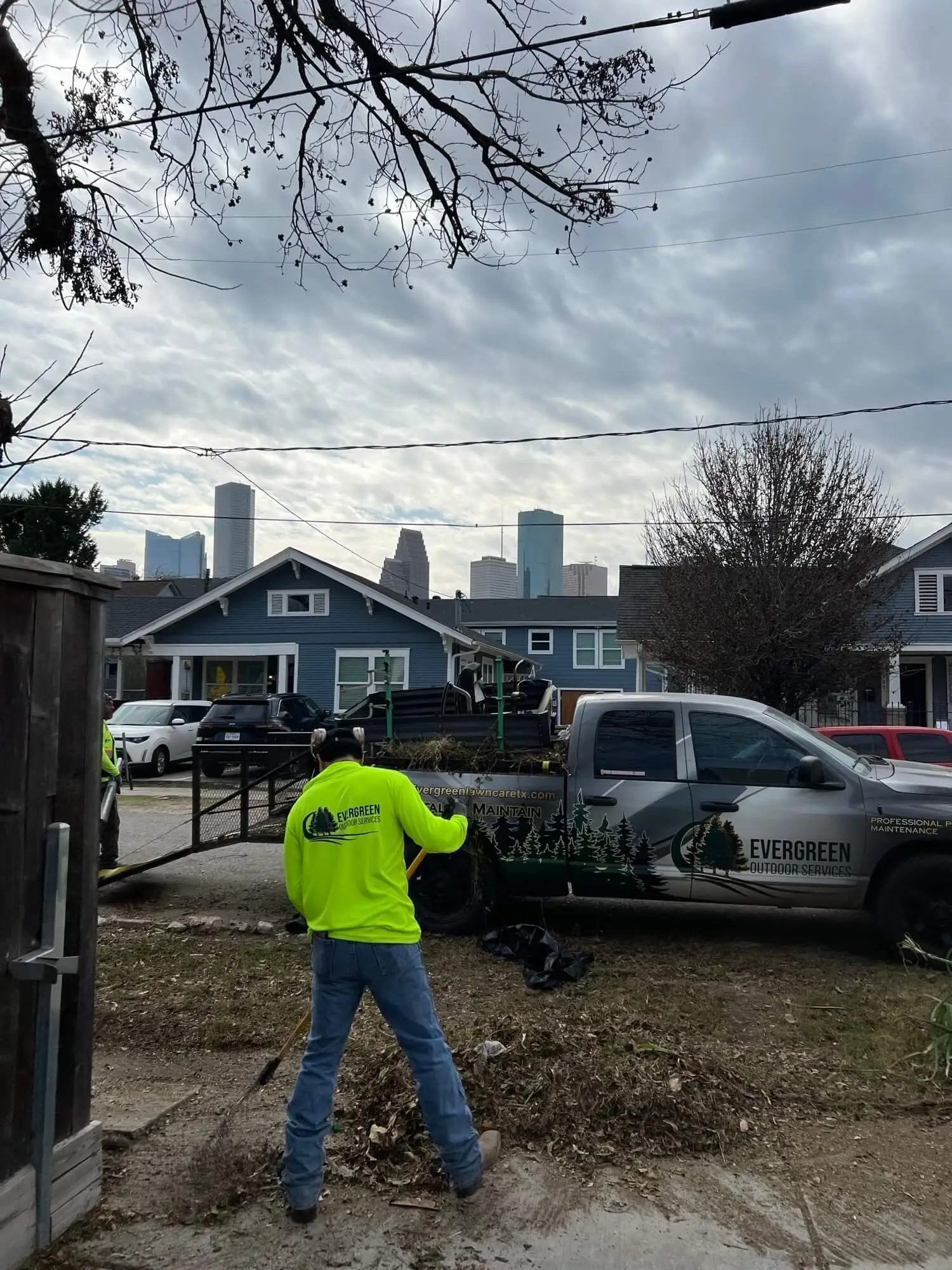 Evergreen crew completing residential yard cleanup work near Downtown Houston