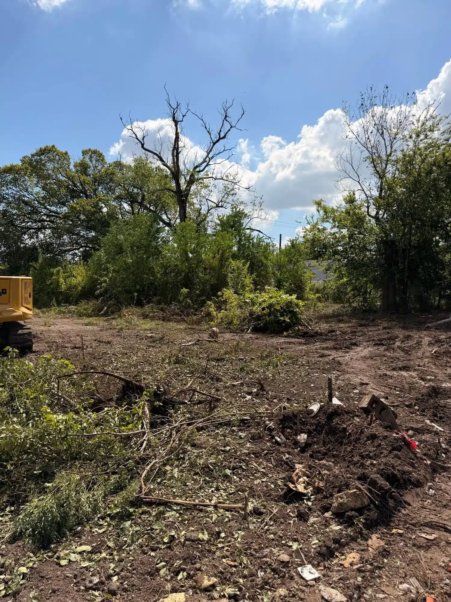 Partially cleared Houston property with brush and cut vegetation during a large land clearing project